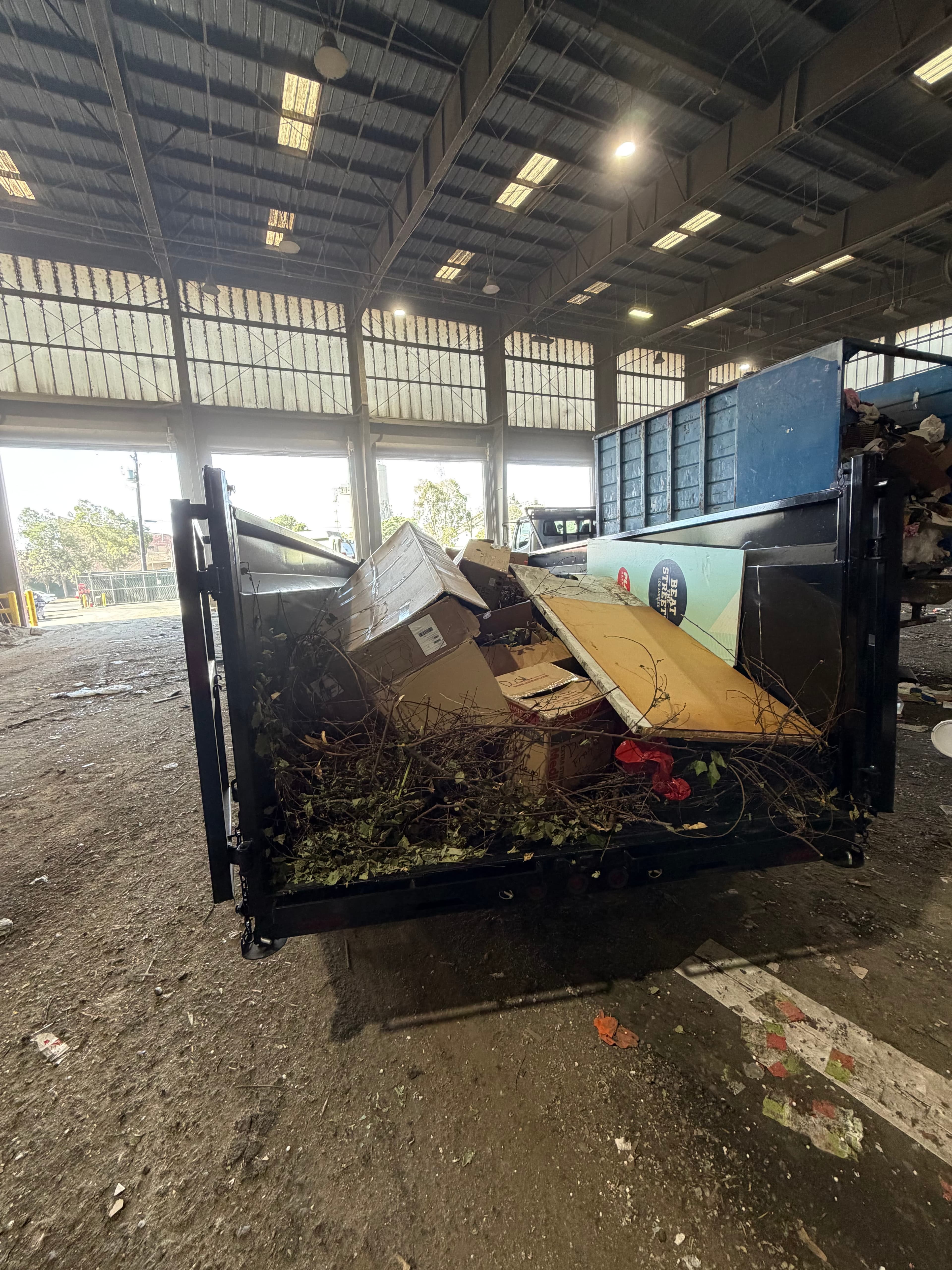 A trailer loaded with cardboard, wood, and yard debris sorted for recycling