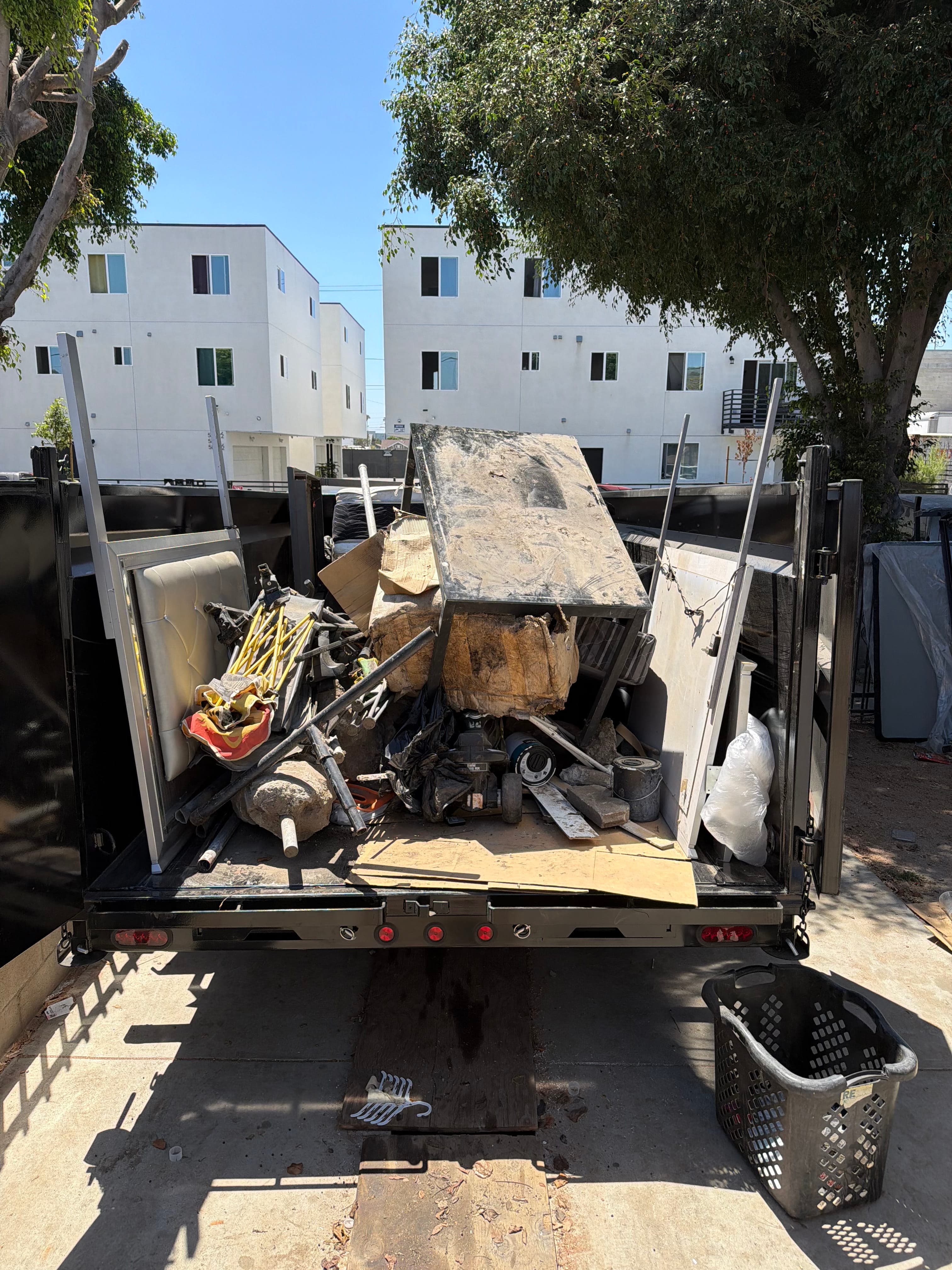 Trailer loaded with furniture and household junk during an apartment clear-out
